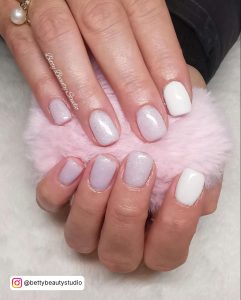 Hands Holding Pink Fur Ball Having Milky Nails With White Glitter