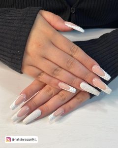 Hands Of A Girl Having Coffin White Nails With Glitter. She Is Wearing A Black Sweater.