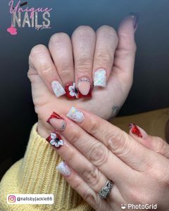 Hands With Red And White Glitter Nails And Silver Pearls