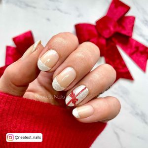 Image Showing Red Sleeves With White Glitter French Tip Nails For Christmas