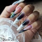 Long Almond Black And White French Tips Nails With Multicolored Glitters Over Net Clothe