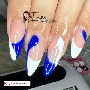 Long Almond Blue And White French Nails With Swirl Design Over Gel Polish Dryer