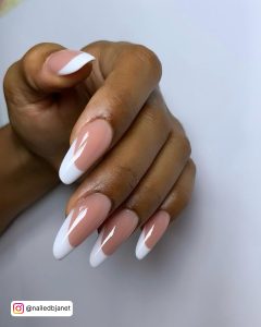 Long Almond White Tip Nails On White Surface