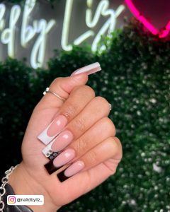 Long Baddie Black White French Nails Over Leafy Background