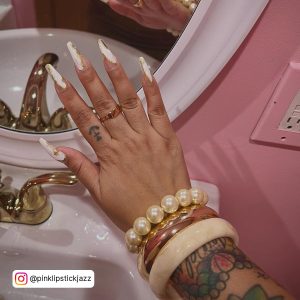 Long Coffin Nails With White Tips And Gold Foilage Accent With Golden And Off-White Jewellery