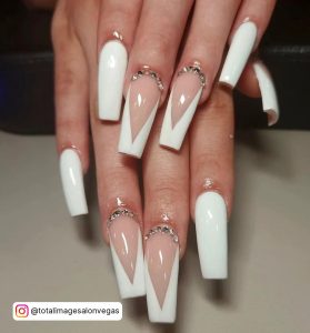Long Coffin White Tip Acrylic Nails Design With Rhinestones Over Cream White Surface
