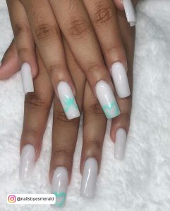 Long Square Tip White Nails With Turquoise Designs On Two Nails