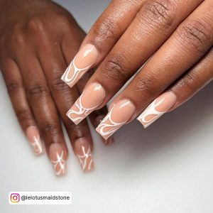 Long Swirly Coffin White Tip Nails On White Surface