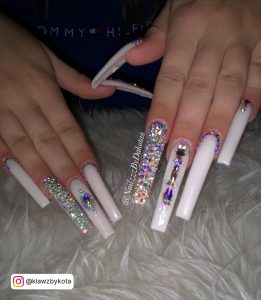 Long White Coffin Nails With Diamonds On A Furry Surface
