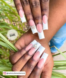 Long White French Tip Nails With Diamonds And Snake Patterned Tips For Baddies