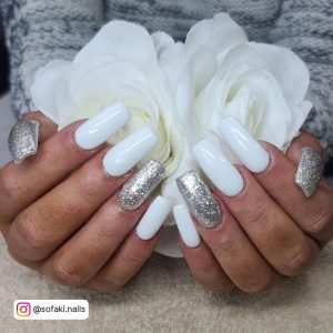 Long White Square Tip Acrylic Nails With A Silver Glitter Ring Finger And A Silver Glitter Thumb