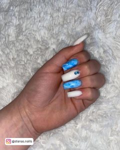 Marble Blue And White Coffin Nails With Plain White Nails And Blue Rhinestones On Grey Fur