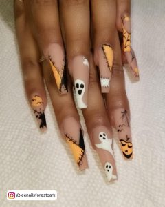 Matte Black And White Nails With A Spooky Halloween Design On Cream Clothe