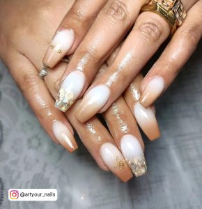 Milky White And Light Brown Ombre Coffin Nails With Gold Glitter On The Feature Nail