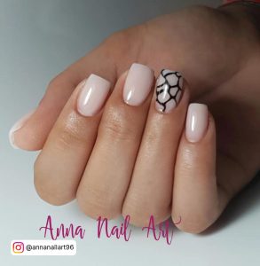 Milky White Square Nails With A Black Design On One Of The Nails