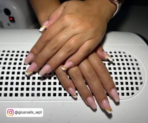 Nude Acrylic Nails With White Tips And Gold Glitter Stripes