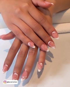 Nude Almond Nails With White Swirl Designs