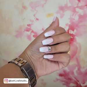 Ombre Pink And White Nails With Butterfly Over Pink And White Surface