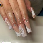 Ombre White Glitter Nail Designs With Pearls Placed Over A White Shelf