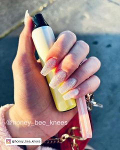 Ombre White Nails With Glitter Paired With A Pink Sweater And Red Cross Bag.