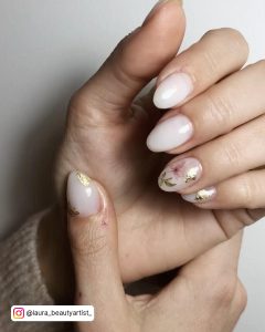 Oval Milky White Nails With Gold Foil And Floral Design
