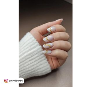 Oval Milky White Nails With Gold Glitter Wavy Line Across Each Nail
