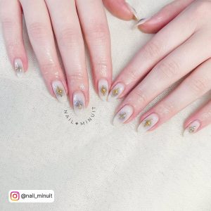 Oval Milky White Nails With Gold Stars And Crosses Decoration