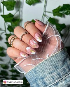 Oval Nude Nails With White Accent And Gold Flakes With Rings