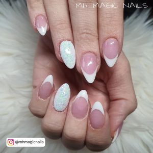 Oval Shaped Pink Nails With White Glitter On The Ring Finger