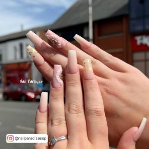 Pastel Spring Acrylic Nails Infront Of A Building