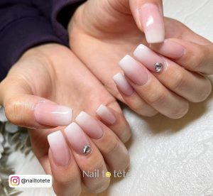 Perfect Ombre Pink White Nails With Diamond Over Milky White Surface