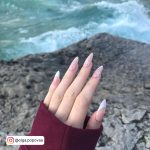 Pink And White Acrylic Nails In Front Of Water