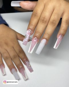 Pink And White Glitter Nails Embellished With Silver Rhinestones Placed Over A White Table