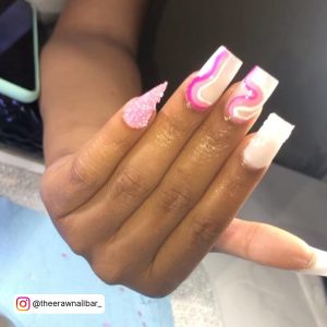 Pink And White Square Nails With Pink Swirl Design And One Triangle Nail