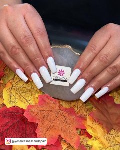 Plain Fall White Acrylic Nail Designs Over Fake Red And Yellow Fall Leaves
