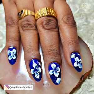 Pretty Royal Blue Nails With White Flowers On White Fur