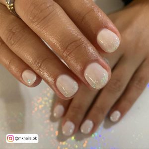 Round White Nails With Glitter Sprinkled Near The Tips