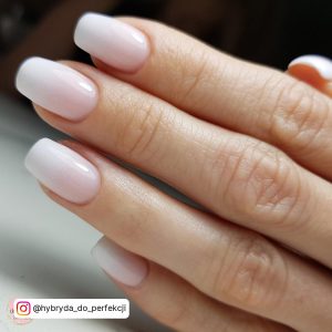 Shimmery Pink White Ombre Nails On Over White Surface