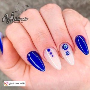 Short Almond Blue And White Nails Design With Eye Art And Glossy Coat