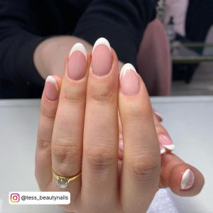 Short Almond Shaped White Tip Nail On White Surface