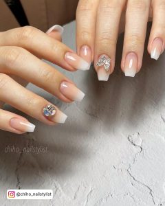 Short Blinge Nude And White Nails Ombre Over White Surface