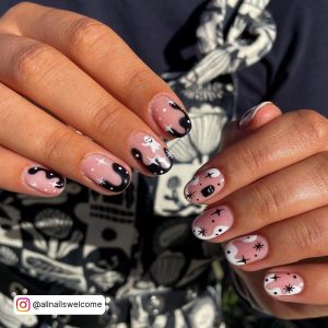 Short Cute Halloween Black N White Nail Art Design With Stars And French Tips On A Patterned Clothe