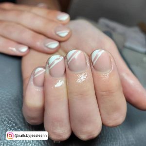 Short Half White Tip Almond Nails On Grey Surface