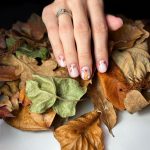 Short Milky White Nails With Red, Orange And Yellow Autumn Leaves On Three Fingers And A Small Fox On One Finger