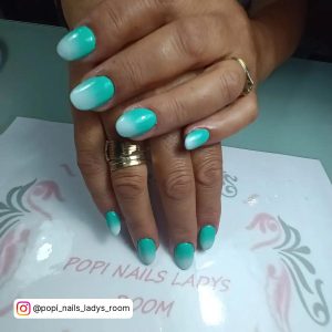 Short Ombre Blue And White Nails On Table Surface