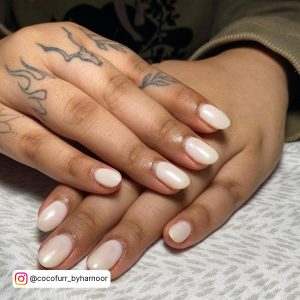 Short Oval Milky White Gel Nails On White Patterned Clothe