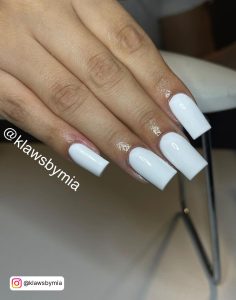 Short Plain White Acrylic Nails Over White Surface