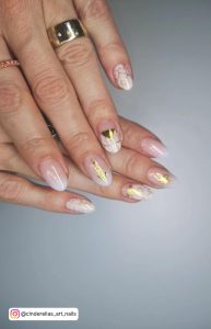 Short Round Nude And White Ombre Nails With Gold Foils With A Golden Ring
