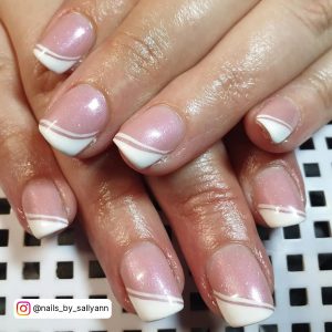Short Shimmery White Tip Acrylic Nails On White And Black Patterned Surface