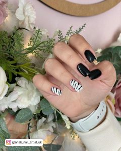 Short Tiger-Print Black And White Simple Nails And Plain Black Nails With Flower In The Background